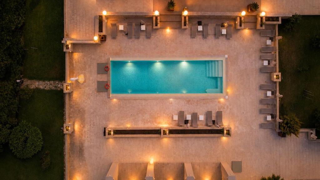 an overhead view of a pool with chairs and lights at Villa Brigida Resort - Soft Luxury Atmosphere - Adult Oriented in Santeramo in Colle