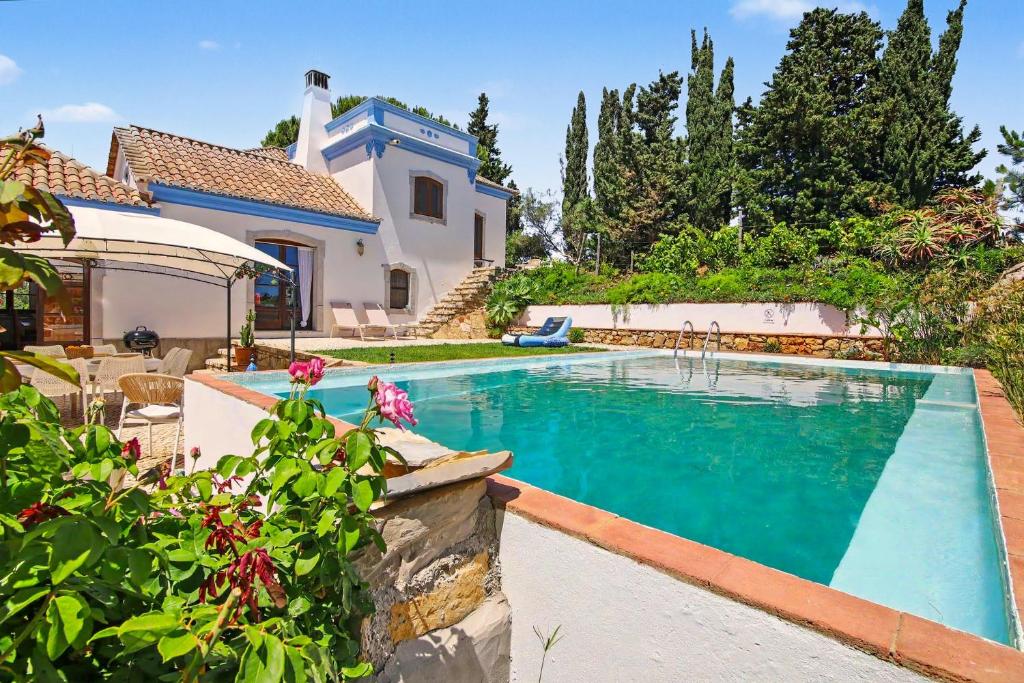 a swimming pool in the backyard of a house at Casa Do Cerro in Luz de Tavira