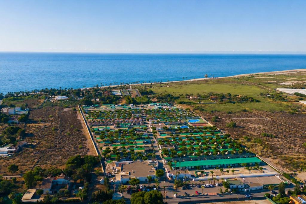 an aerial view of a parking lot next to the ocean at Kampaoh Roquetas in Roquetas de Mar