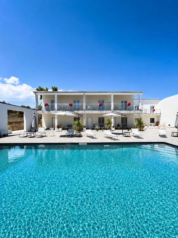 a large swimming pool in front of a building at Omai suite in Ortona