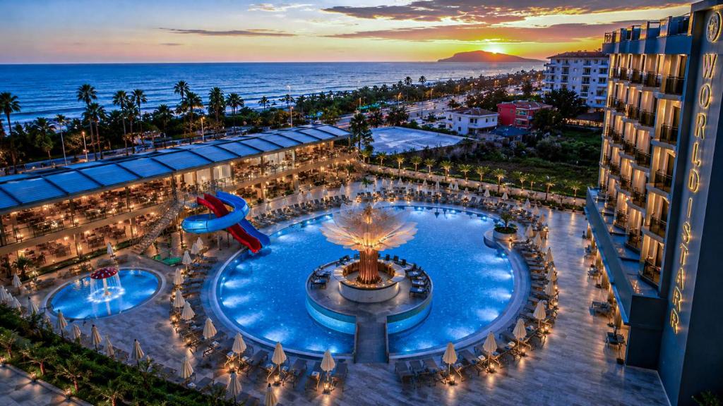 an aerial view of a resort with a pool and the ocean at World Star Beach Resort & Spa in Alanya