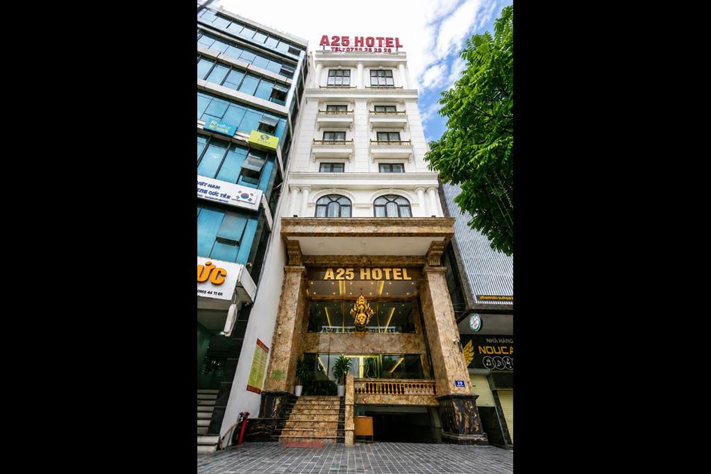 a tall white building with a sign on it at A25 Premium Hotel - 16 Miếu Đầm in Hanoi