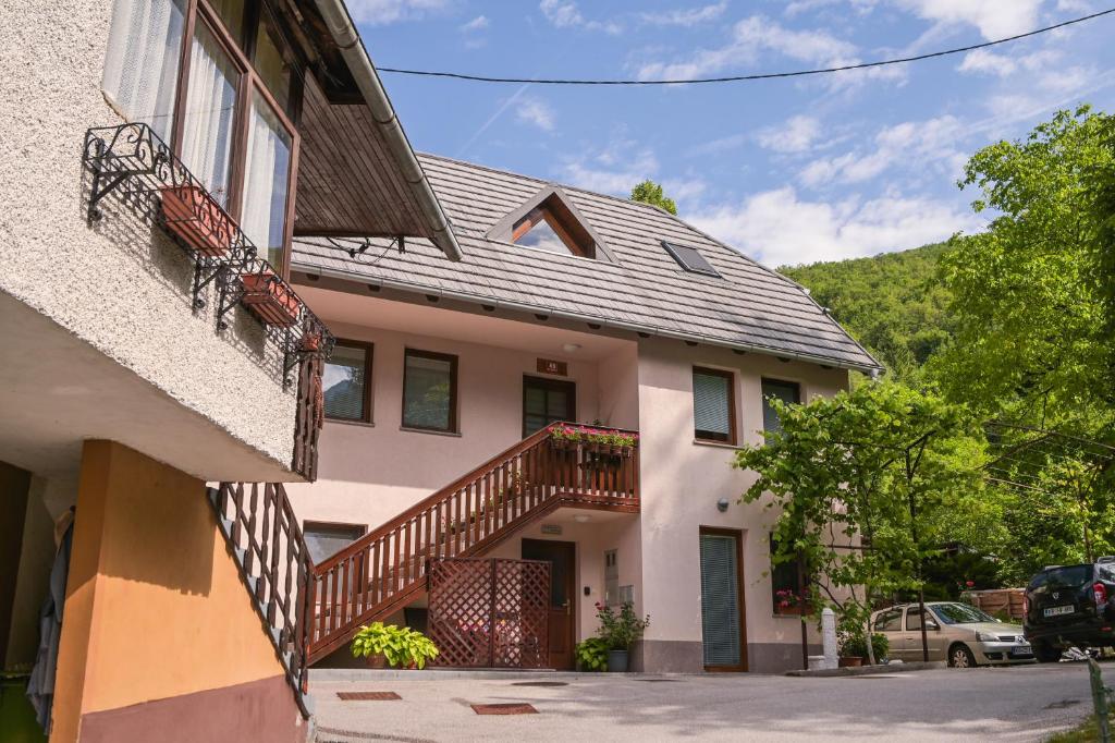 a house with a staircase on the side of it at Počitniško stanovanje Aurora in Bovec