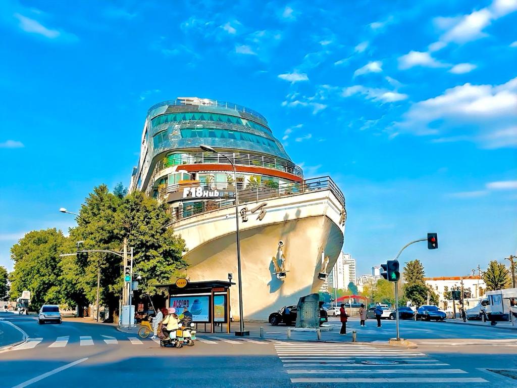 a large building on the corner of a street at F18 Hub Youth Hostel in Chengdu