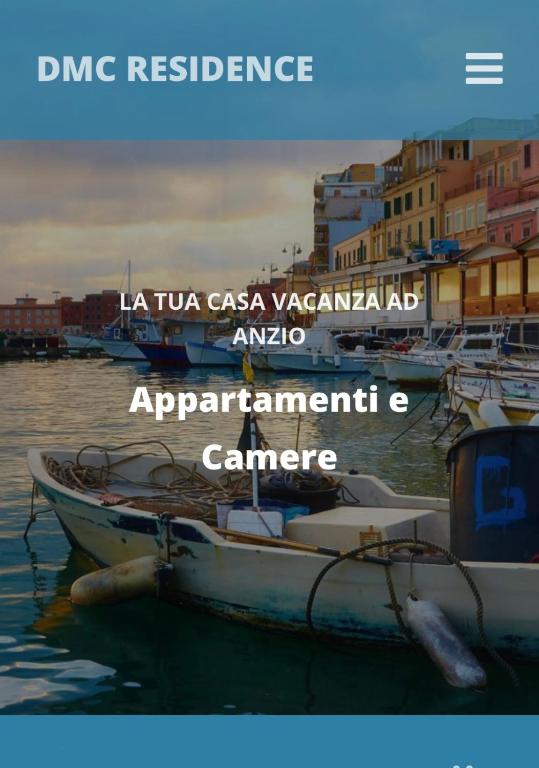 a group of boats in the water with buildings at DMC - Alloggio Turistico in Anzio