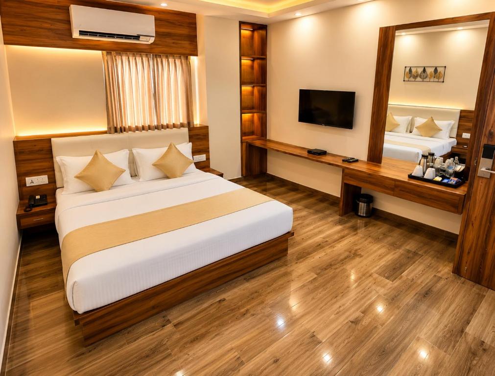 a hotel room with a bed and a mirror at Namastey Puri Hotel - Near Jagannath Dham Temple With Restaurant And Parking Facility Fully Air Conditioning Room in Puri