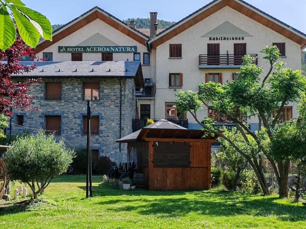 a building with a bird house in front of it at Hotel Acebo & Natura in Castiello de Jaca