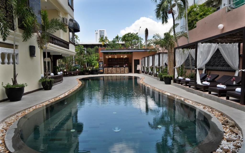a swimming pool in the middle of a building at The Palace Indochine Hotel in Siem Reap