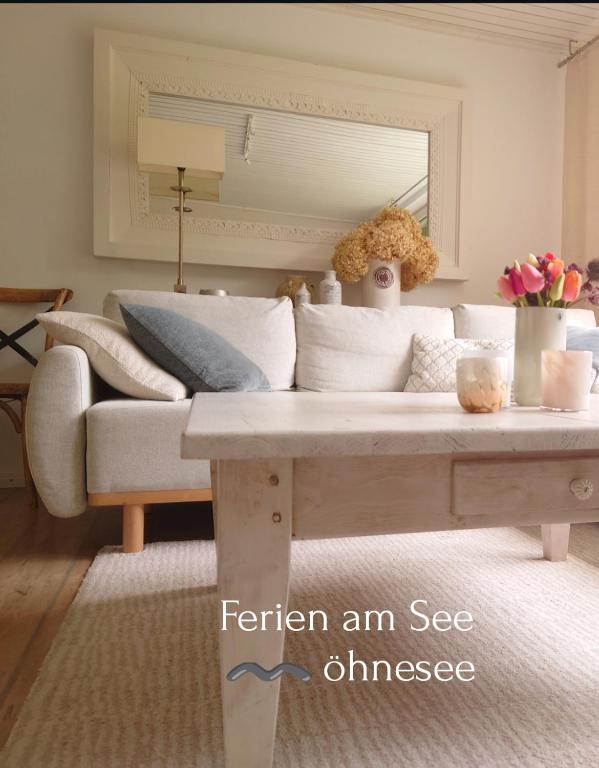 a living room with a couch and a coffee table at Ferien am See in Möhnesee