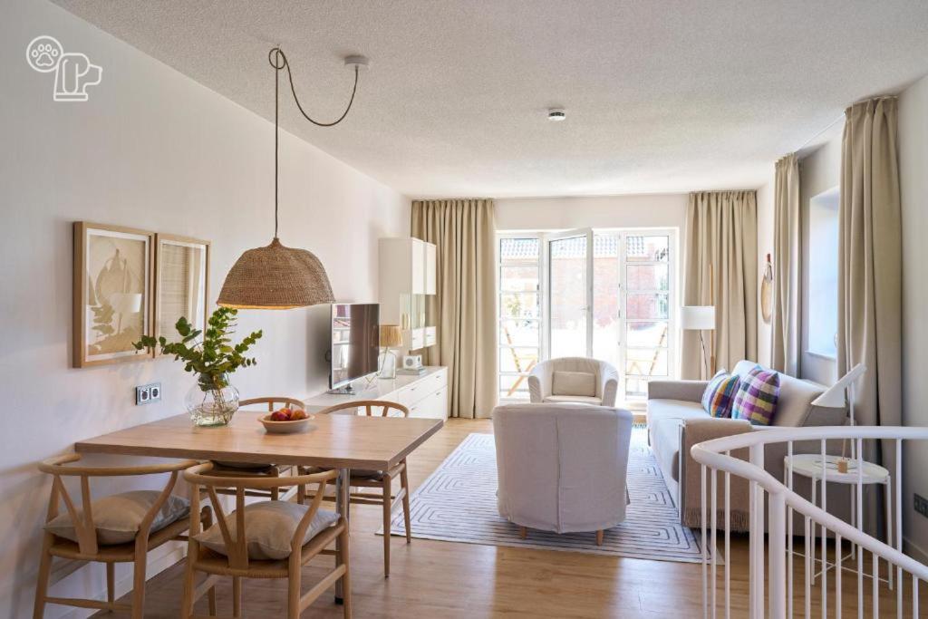 a kitchen and living room with a table and chairs at Haus Nordstrand in Norderney