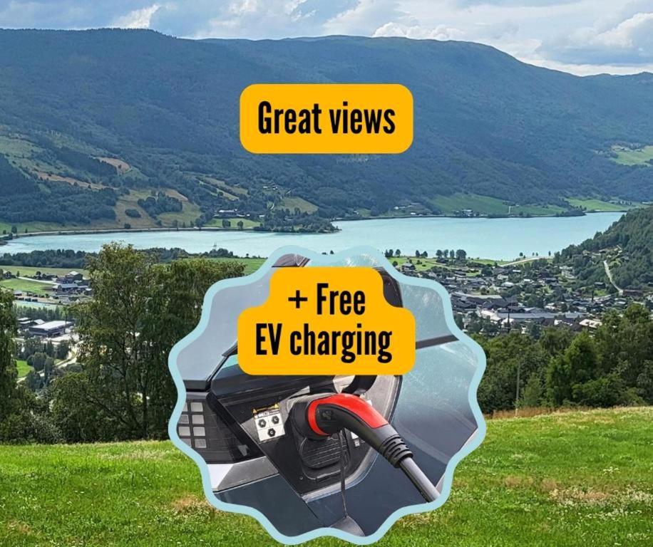 a camera on a hill with a view of a lake at Free EV Charging with Snacks and View in Blesom