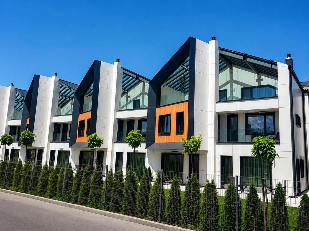 an apartment building with a fence in front of it at Complex SamElyon Residence in Samokov