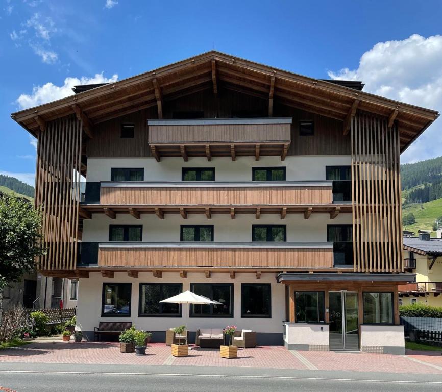 a large building with a gambrel roof at Pension Norika in Saalbach-Hinterglemm