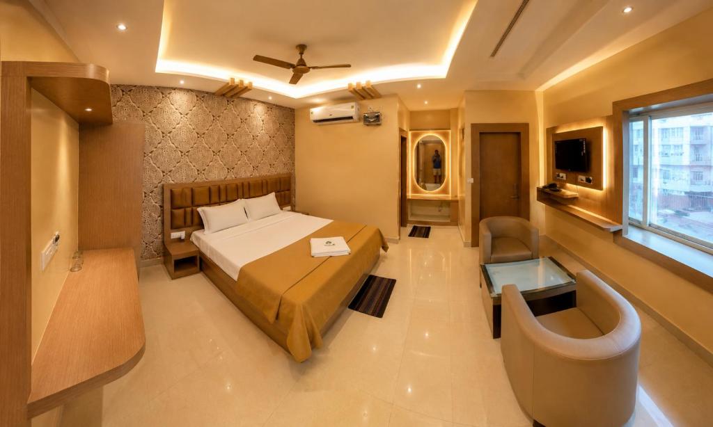 a hotel room with a bed and a window at Hotel Baikuntha International Puri Near Sea Beach With Parking AC Or Non AC Both Room in Puri
