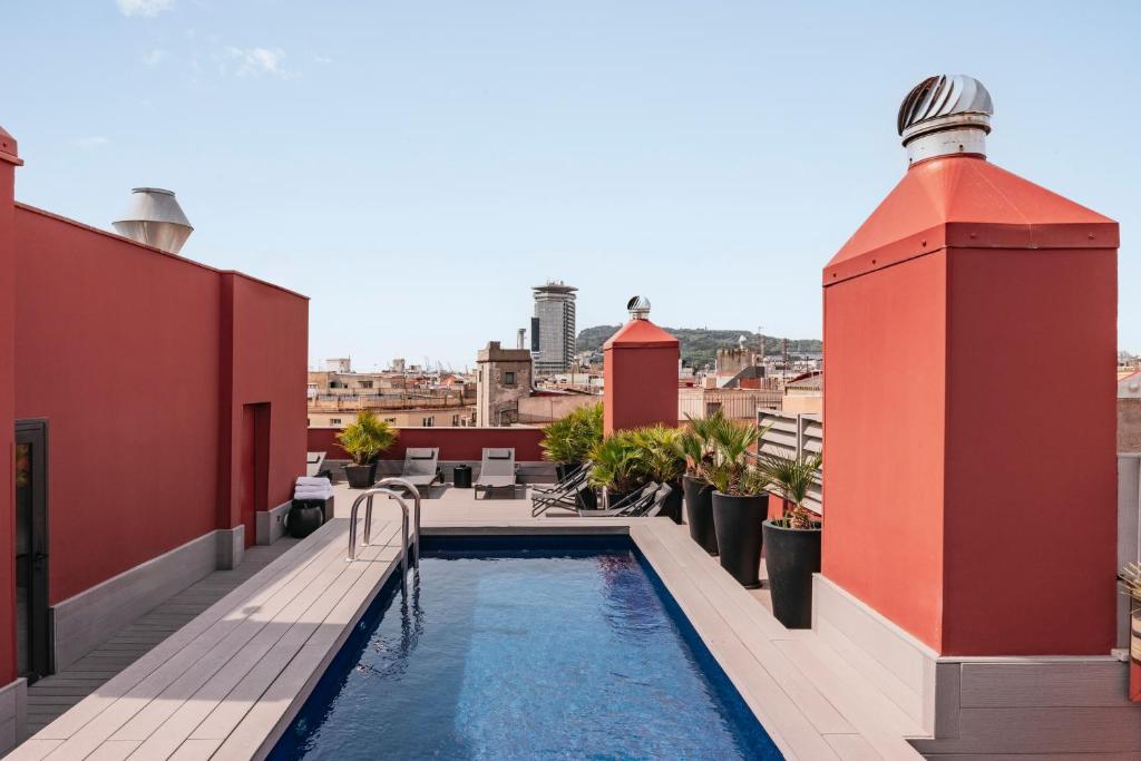 a swimming pool on the roof of a building at Aparthotel Arai 4* Superior in Barcelona