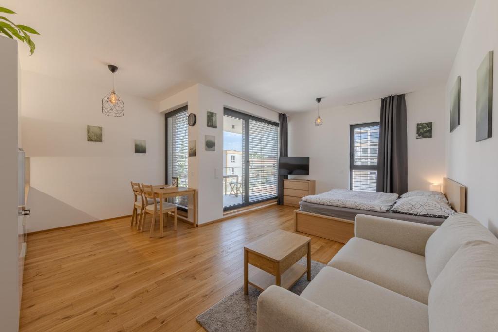 a living room with a couch and a bed and a table at Island Safehouse in Olomouc