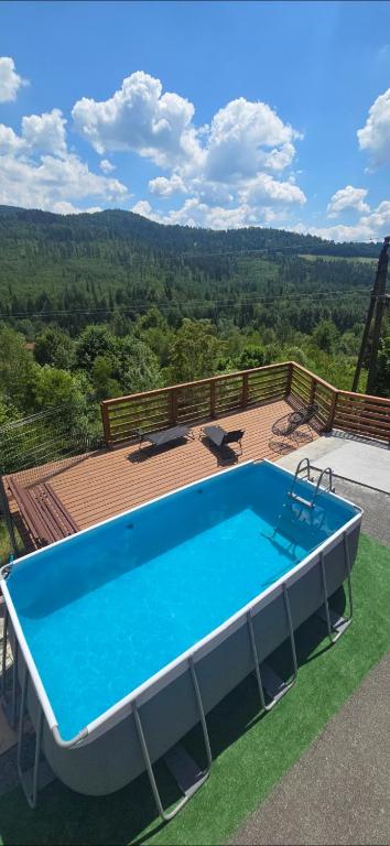 a swimming pool on top of a deck with a view at Dom na Cieńkowie in Wisła