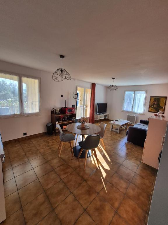a living room with a table and chairs and a couch at La Verdière in Barjols