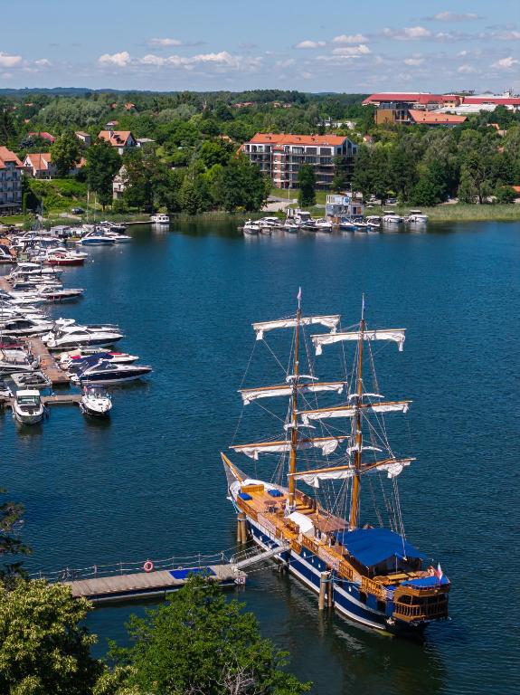 a group of boats docked in a harbor at Lake Rental Spacerowa in Mikołajki