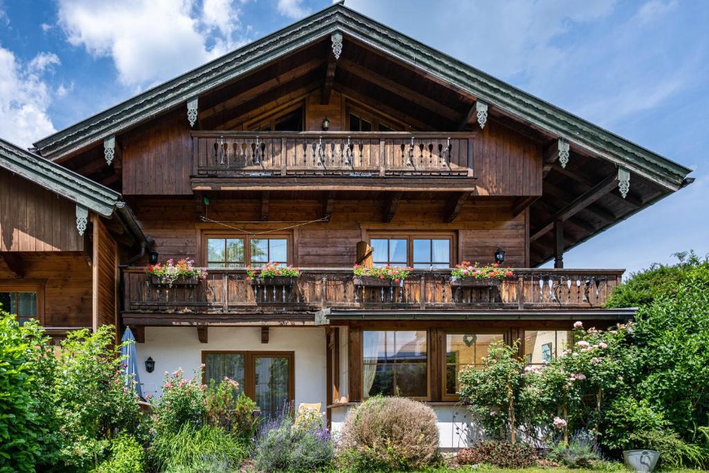 a large wooden house with a balcony at Weibhauser Franzl in Ruhpolding