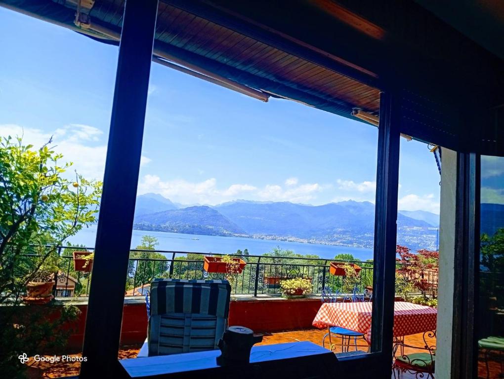 a view of the water from the balcony of a house at L'attico Con Terrazza Vista Lago in Laveno-Mombello