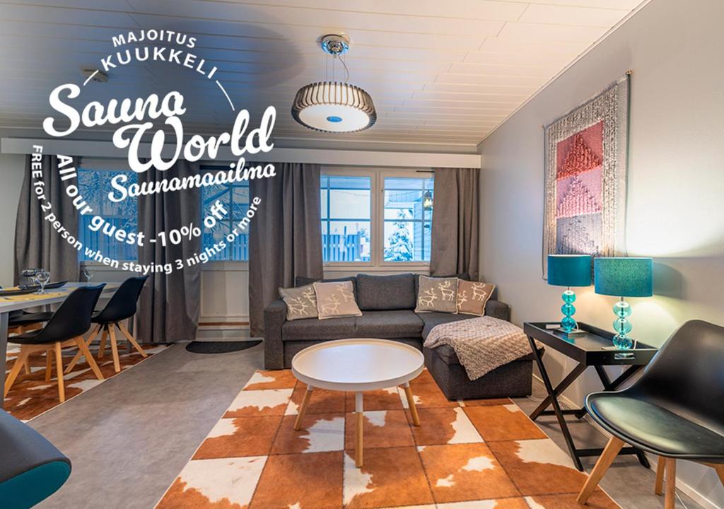 a living room with a couch and a table at Kuukkeli Apartments in Saariselka