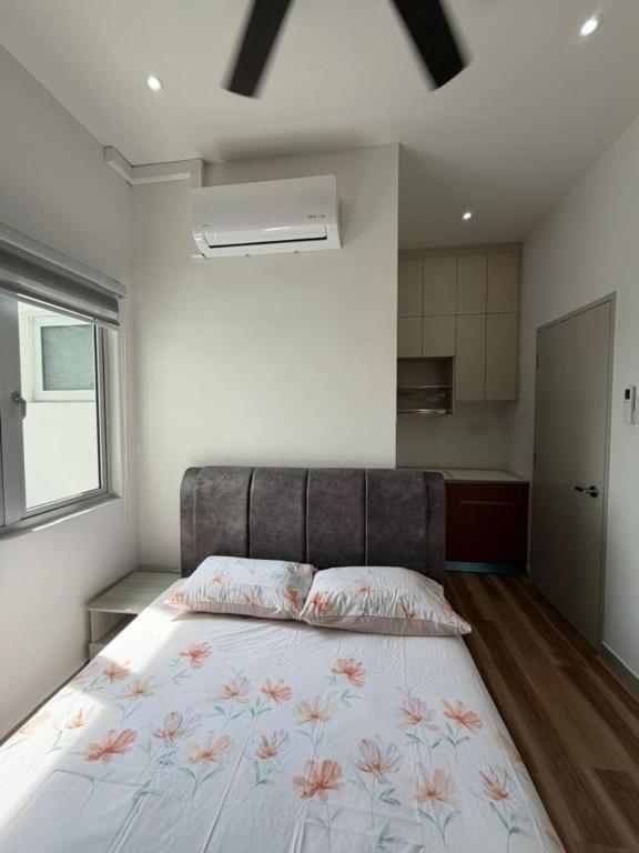 a bedroom with a large bed with flowers on it at Sufi Idaman Studio for Islamic only in Nilai