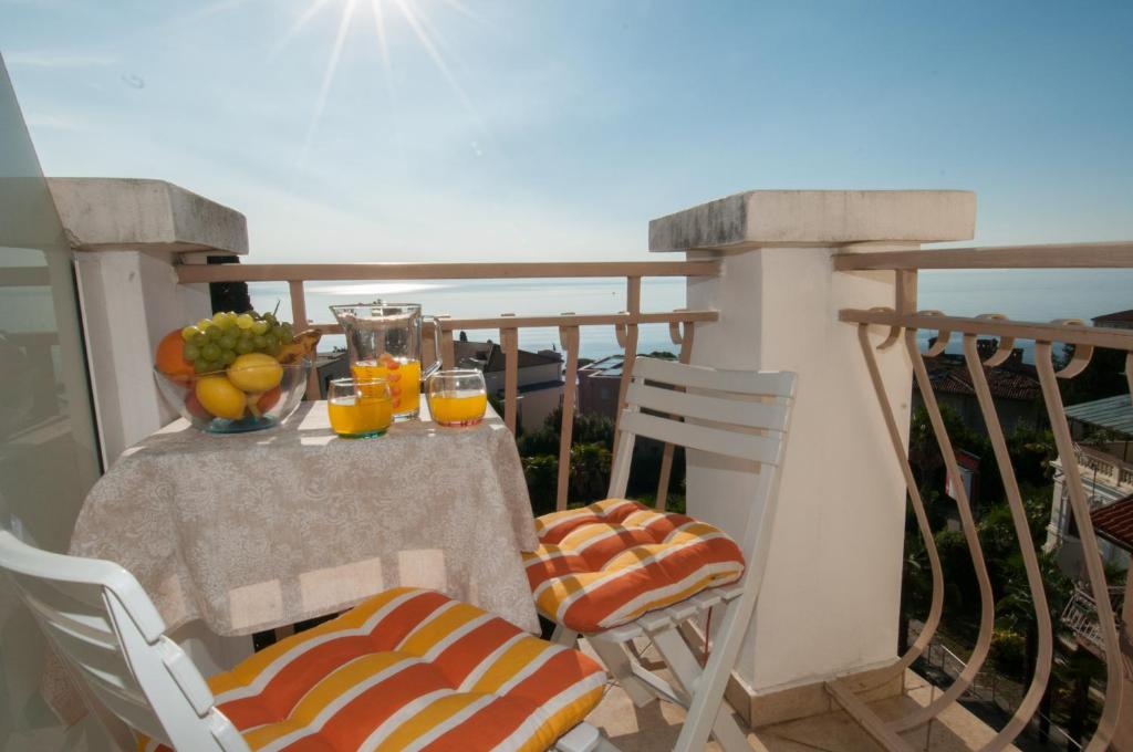 a table with oranges and juice on a balcony at Iva 1, wonderful view of Kvarner Bay in Opatija