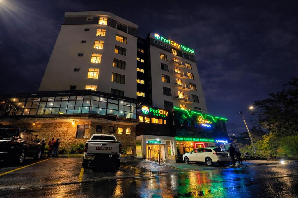 a hotel building with a car parked in front of it at Pori City Hotel in Nairobi