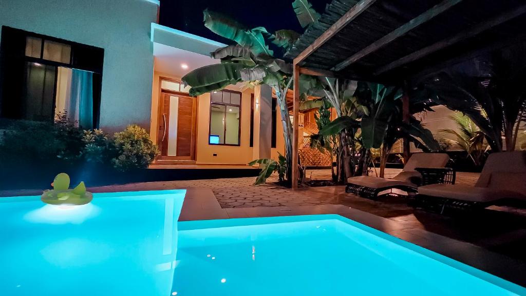 a swimming pool in a yard at night at Matemwe Bluu Villa in Matemwe