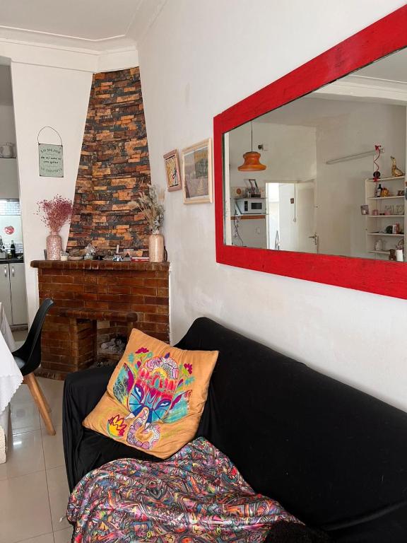 a living room with a couch and a mirror at Casa Olivos in Olivos