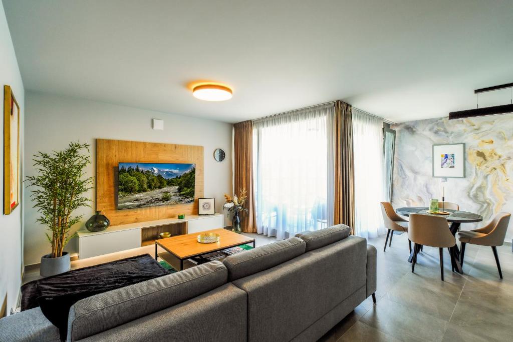 a living room with a couch and a table at Victory port Apartmán in Liptovský Mikuláš
