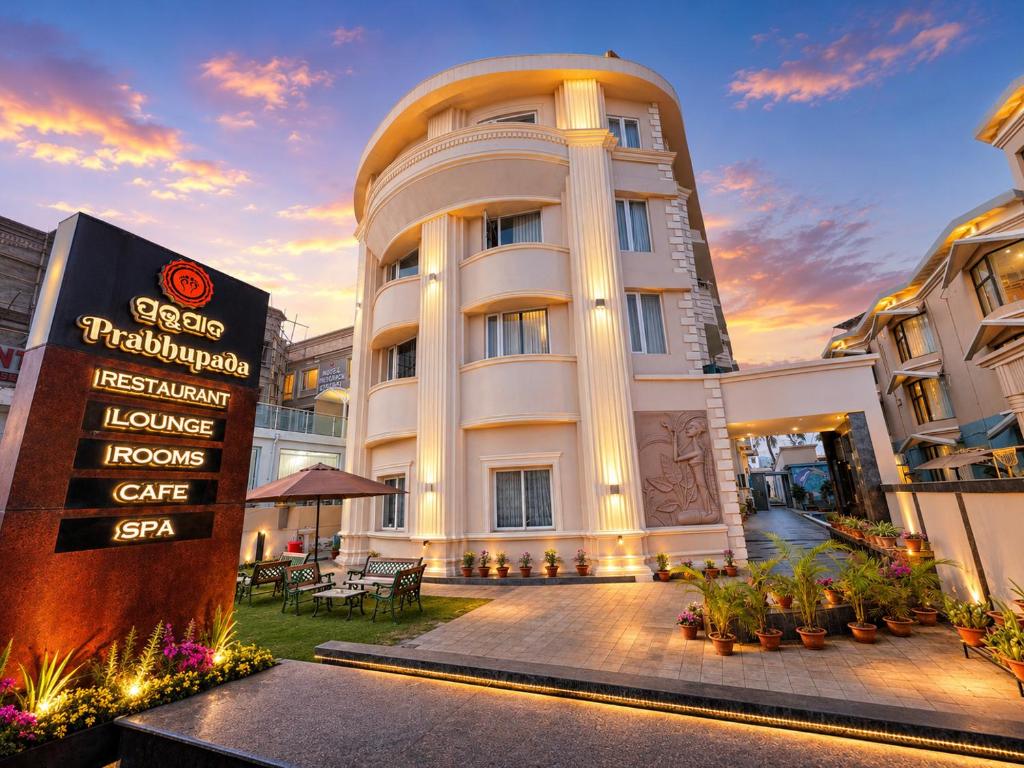 a large white building with a sign in front of it at Hotel Prabhu Pada Puri - Beach Front Hotel With Swimming Pool And Restaurant - SPA- Banquet - Parking Facility in Puri