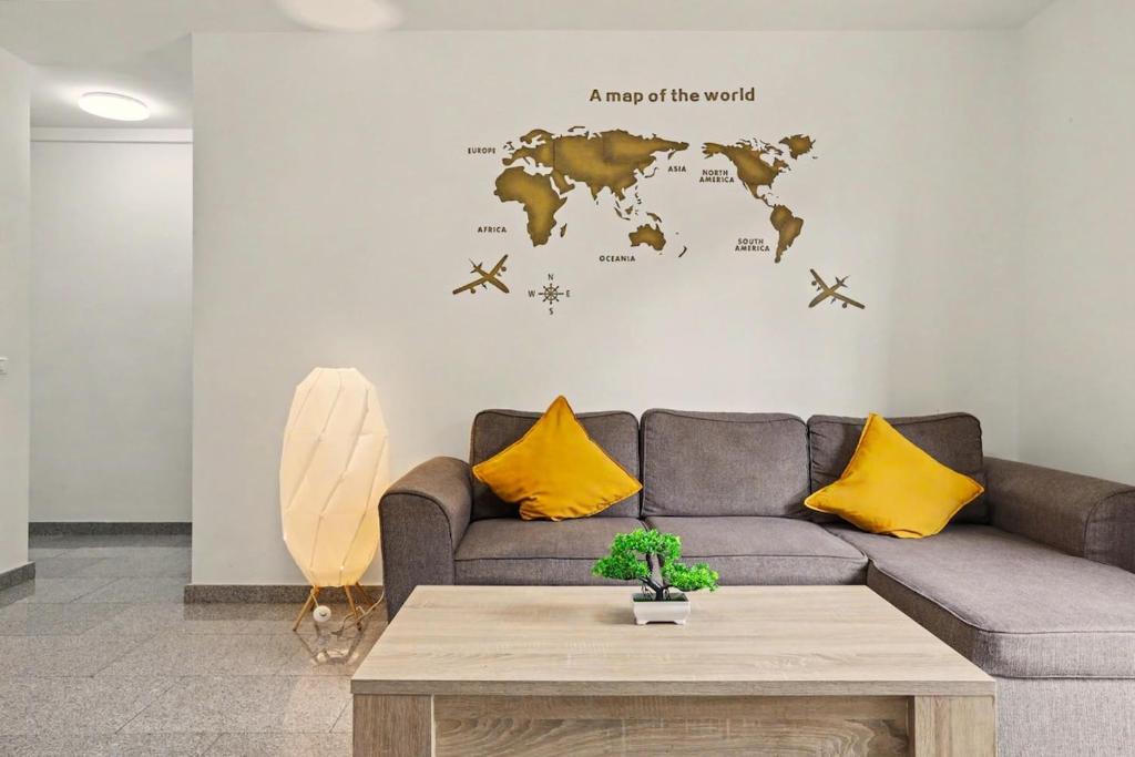 a living room with a couch and a map of the world at NG CANDELARIA - Tenerife in Candelaria