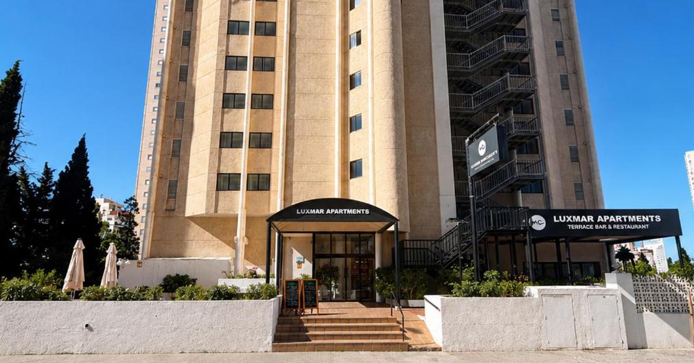 a large building with a entrance to a building at Luxmar Apartaments By MC in Benidorm