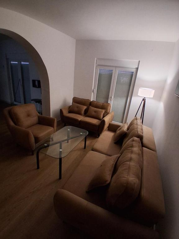 ein Wohnzimmer mit einer Couch, zwei Sesseln und einem Tisch in der Unterkunft Radoš in Igalo