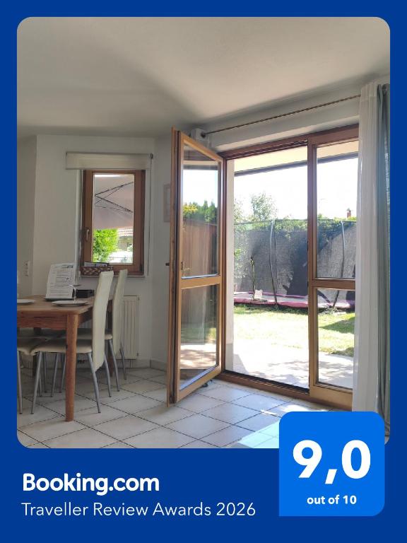 an open sliding glass door in a room with a table at Ferienwohnung am Trillenbühl in Salem
