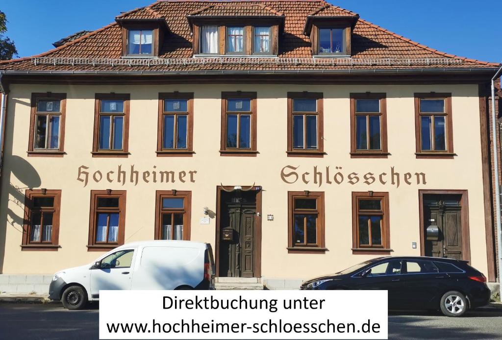 a building with cars parked in front of it at Pension Hochheimer Schlösschen in Erfurt