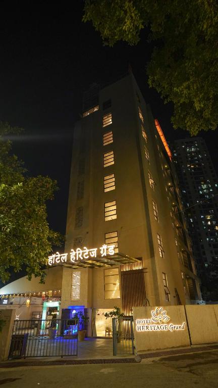 a large building with lights on it at night at Hotel Heritage Grand in Thane