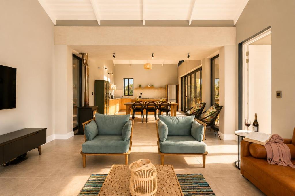 a living room with two chairs and a table at 401 Kingfisher in Gansbaai