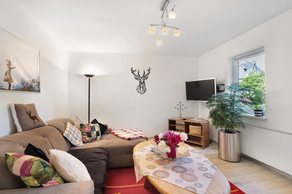 a living room with a couch and a table at Fewo Diemelrauschen in Eimelrod