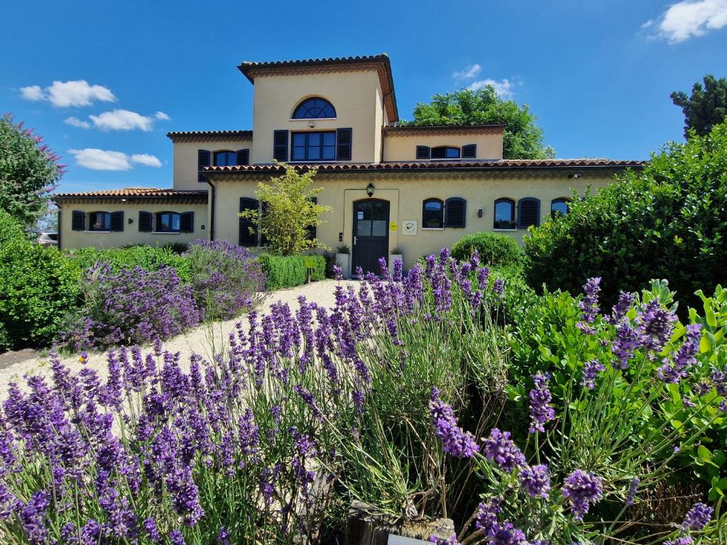 a house with purple flowers in front of it at Casa René in Aalter