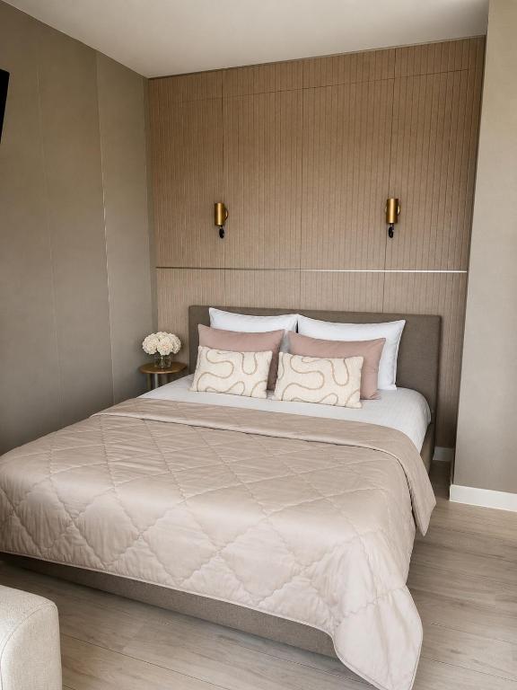 a bedroom with a large white bed with pillows at Maison Lumière - Private Rooftop terrace in Amsterdam