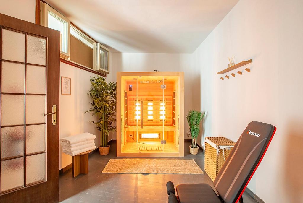 a room with a hallway with a door and a chair at Lake Como with view, sauna and air conditioning in Mandello del Lario