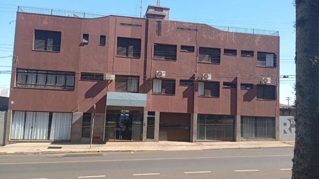 a brown building on the side of a street at Residence Hotel in Jaú