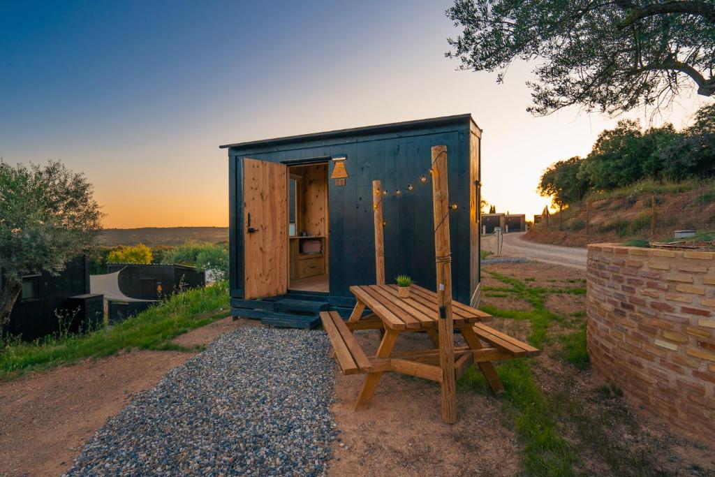 a blue shed with a picnic table and a bench at Kampaoh Alquézar in Alquézar