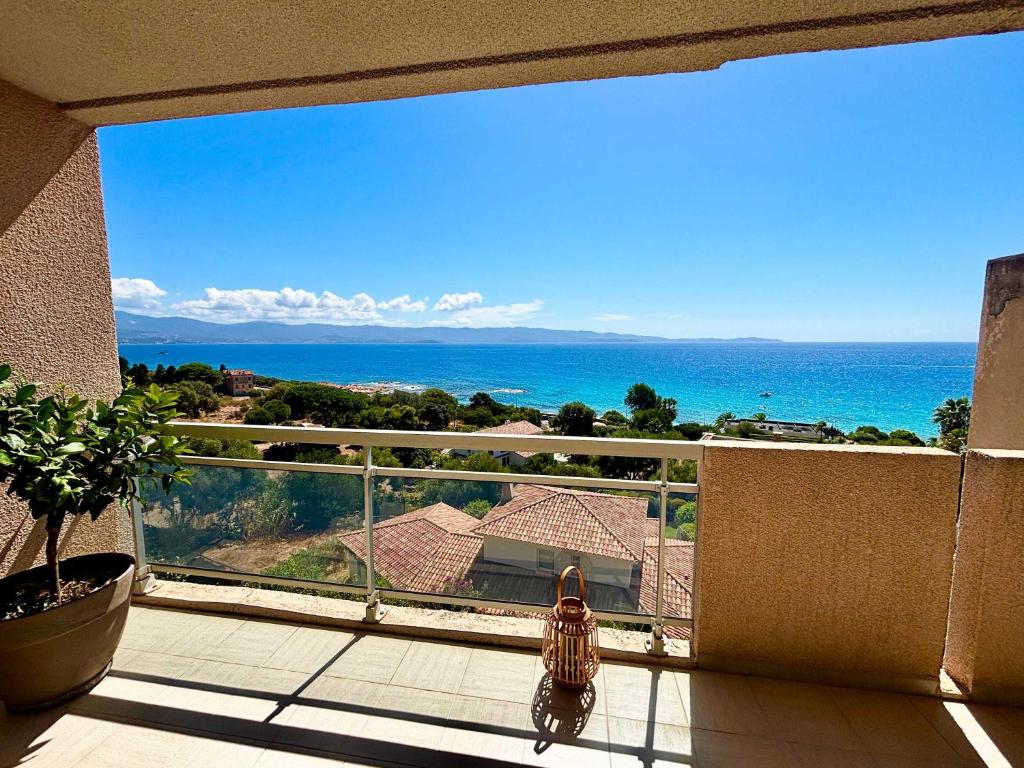 a child standing on a balcony looking at the ocean at Casamea - Terrasse Mer, Plage 5min, Barbicaja in Ajaccio
