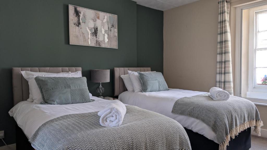 a bedroom with two beds with towels on them at The Bugle Inn in Bugle