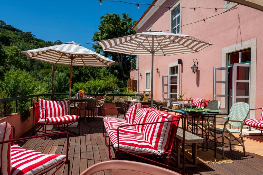 a group of chairs and umbrellas on a patio at WOT Sarrazola Soul in Sintra