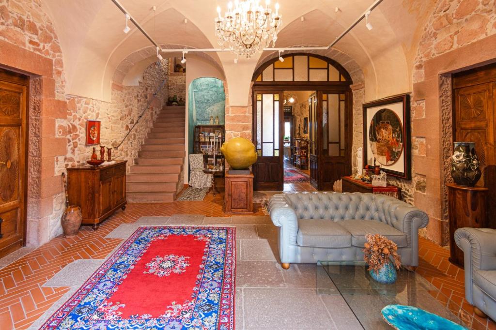 a living room with a couch and a rug at S'Asilo Boutique B&B - North Sardinia - Village stay in Banari